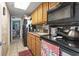 Efficient kitchen featuring wooden cabinetry and modern appliances, with a view to the adjacent room at 6804 North Ocean Blvd. # 515, Myrtle Beach, SC 29572