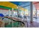 A large indoor pool area with plenty of seating and bright, colorful decor at 6804 North Ocean Blvd. # 515, Myrtle Beach, SC 29572