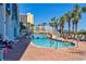 Exterior of a pool with a bridge, surrounded by palm trees and lounge chairs for ultimate relaxation at 6804 North Ocean Blvd. # 515, Myrtle Beach, SC 29572