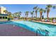 Outdoor pool with clear blue water, surrounded by palm trees and lounge chairs at 6804 North Ocean Blvd. # 515, Myrtle Beach, SC 29572