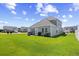 Inviting backyard with lush green grass, an outdoor patio, and various amenities for relaxation and entertainment at 715 Hobonny Loop, Longs, SC 29568