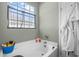 Bright bathroom featuring a white garden tub, and a window letting in natural light at 715 Hobonny Loop, Longs, SC 29568