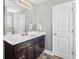 Bathroom featuring a dark wood vanity with white countertop and a large mirror at 715 Hobonny Loop, Longs, SC 29568