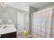 Bathroom features a shower with colorful shower curtain, single sink vanity, and wood look floors at 715 Hobonny Loop, Longs, SC 29568