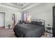 Bedroom with tray ceiling, ceiling fan, and good natural lighting at 715 Hobonny Loop, Longs, SC 29568