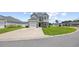Charming two-story home featuring a well-manicured lawn, stone accents, a two-car garage, and inviting curb appeal at 715 Hobonny Loop, Longs, SC 29568