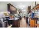 Spacious kitchen with dark wood cabinets, granite countertops, stainless steel appliances, and hardwood flooring at 715 Hobonny Loop, Longs, SC 29568