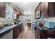 Modern kitchen featuring dark wood cabinetry, granite countertops, stainless steel appliances, and wood flooring at 715 Hobonny Loop, Longs, SC 29568