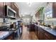 Modern kitchen with stainless steel appliances, dark cabinetry, and an open layout at 715 Hobonny Loop, Longs, SC 29568
