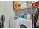 Functional laundry area with modern white washer and dryer, convenient shelving, and organized storage solutions at 715 Hobonny Loop, Longs, SC 29568
