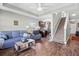 Cozy living room featuring a comfortable sofa, stairs, and view into the kitchen at 715 Hobonny Loop, Longs, SC 29568