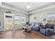 Inviting living room with wood floors, a cozy couch, and a large window with bright lighting at 715 Hobonny Loop, Longs, SC 29568