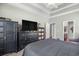 Main bedroom featuring a tray ceiling, ceiling fan, and dark wood furnishings at 715 Hobonny Loop, Longs, SC 29568