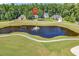 Beautiful aerial view of a golf course community featuring a serene pond and lush green landscaping at 765 Shaftesbury Ln., Conway, SC 29526