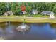Scenic neighborhood aerial featuring a tranquil pond with a fountain and well-maintained landscaping at 765 Shaftesbury Ln., Conway, SC 29526