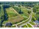 Expansive aerial view of a golf course community with multiple greens, a tranquil pond, and well-maintained landscaping at 765 Shaftesbury Ln., Conway, SC 29526