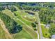 Aerial view of a golf course community featuring a serene pond and lush green landscaping at 765 Shaftesbury Ln., Conway, SC 29526