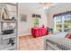Bright bedroom features a red table, ceiling fan, and large windows for natural light at 765 Shaftesbury Ln., Conway, SC 29526