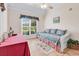 Bright bedroom features a red table, ceiling fan, and large windows for natural light at 765 Shaftesbury Ln., Conway, SC 29526