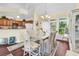 Bright dining room with a chandelier, large windows, and an adjacent kitchen area at 765 Shaftesbury Ln., Conway, SC 29526