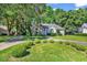 Beautiful single-story home with stone accents, mature trees, and manicured lawn at 765 Shaftesbury Ln., Conway, SC 29526