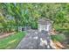 A detached garage has a driveway and faces a wooded area at 765 Shaftesbury Ln., Conway, SC 29526