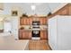 Well-equipped kitchen with wooden cabinetry, tile flooring, and modern appliances at 765 Shaftesbury Ln., Conway, SC 29526