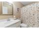Cozy bathroom with a single sink vanity, decorative mirror, toilet and shower/tub combination at 943 Oak St., Aynor, SC 29511