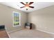 Simple bedroom design showcasing a window, carpeted floors, a ceiling fan and minimal furnishings at 943 Oak St., Aynor, SC 29511