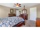 Bedroom showcasing a wooden four-poster bed, ceiling fan, carpeted floors and traditional furnishings at 943 Oak St., Aynor, SC 29511