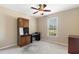 Bright bedroom features a ceiling fan, natural light, built in desk, and carpeted floors at 943 Oak St., Aynor, SC 29511