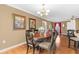 Elegant dining area with hardwood floors, chandelier lighting, and a view into the adjoining living room at 943 Oak St., Aynor, SC 29511