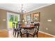 Cozy dining room with hardwood floors, a round table, and sliding glass doors leading to the backyard at 943 Oak St., Aynor, SC 29511