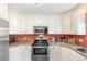 Well-lit kitchen with stainless steel appliances and ample cabinet space for storage and organization at 943 Oak St., Aynor, SC 29511