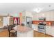 Spacious kitchen with stainless steel appliances, breakfast bar, and open view to the living room at 943 Oak St., Aynor, SC 29511