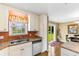 Kitchen featuring stainless steel sink, dishwasher, and a view of the backyard through a bright window at 943 Oak St., Aynor, SC 29511