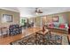 Inviting living room with hardwood floors, a ceiling fan, and a seamless transition to the dining area at 943 Oak St., Aynor, SC 29511
