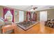 Inviting living room featuring hardwood floors, a ceiling fan, and access to the front door at 943 Oak St., Aynor, SC 29511