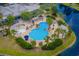 Stunning aerial view of the community pool, lush landscaping, and surrounding water features at Lot 142 Millbank Rd., Georgetown, SC 29440