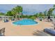 Inviting community pool surrounded by palm trees and comfortable lounge chairs at Lot 142 Millbank Rd., Georgetown, SC 29440