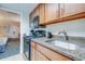 The kitchen features granite counters and wooden cabinetry at 1105 S Ocean Blvd. # 128, Myrtle Beach, SC 29577