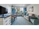 Living room area featuring a sofa, table, and balcony at 1105 S Ocean Blvd. # 128, Myrtle Beach, SC 29577