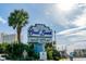 Coral Beach sign with palm trees showcasing resort amenities like bowling, a recreation center, bars and 10 pools at 1105 S Ocean Blvd. # 128, Myrtle Beach, SC 29577