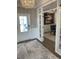 Inviting foyer with elegant chandelier, wainscotting, and a view into the living room at 121 Eagle Claw Dr., Carolina Shores, SC 28467