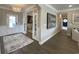Inviting foyer with an elegant chandelier, hardwood floors, and access to multiple rooms at 121 Eagle Claw Dr., Carolina Shores, SC 28467