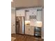 Kitchenette featuring white cabinets, stainless steel appliances, a wine fridge, and elegant countertops at 121 Eagle Claw Dr., Carolina Shores, SC 28467
