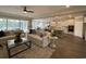 Open-concept living room with hardwood floors, comfortable sofas, and a view into the kitchen and dining area at 121 Eagle Claw Dr., Carolina Shores, SC 28467