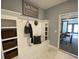 Mudroom with built-in storage, bench, and decorative baskets for organization, adjacent to a dining area at 121 Eagle Claw Dr., Carolina Shores, SC 28467