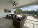 Screened-in patio featuring comfortable seating and an outdoor dining area with a view of the backyard at 121 Eagle Claw Dr., Carolina Shores, SC 28467