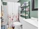 Bathroom featuring a shower with floral curtain, white vanity, and efficient storage at 1301 Pridgen Rd. # 903, Myrtle Beach, SC 29577